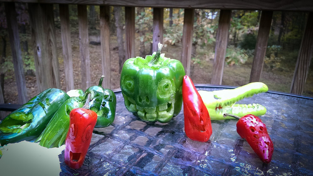Chilli peppers carved into jack-o-lanterns, scary