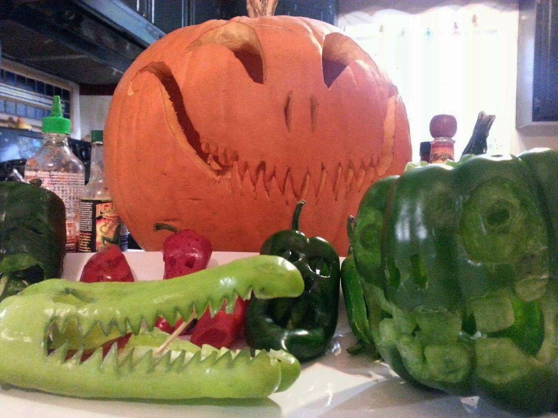 Pumpkin and carved peppers for halloween before lighting
