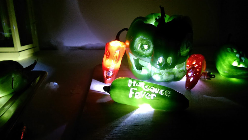 Carved peppers lit up for halloween, Hot Sauce Fever