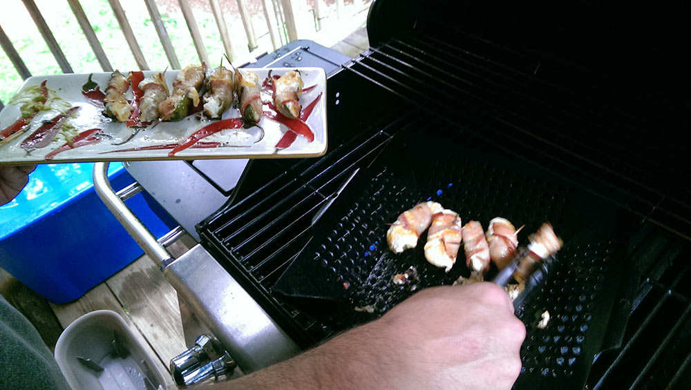 Poppers being removed from the grill tray