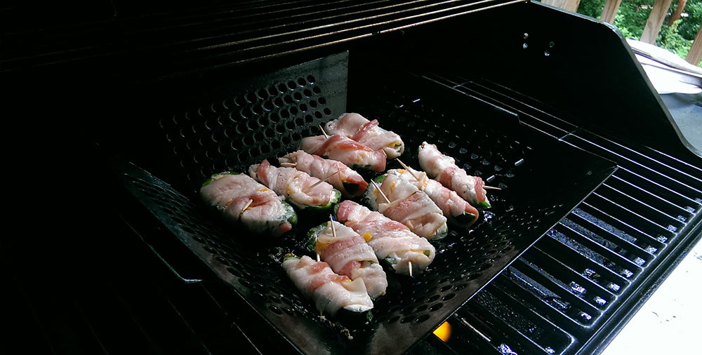 Grilling jalapeno poppers wrapped in bacon